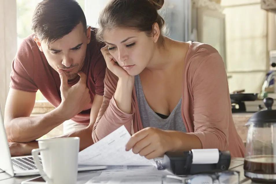a couple looking at bank statements