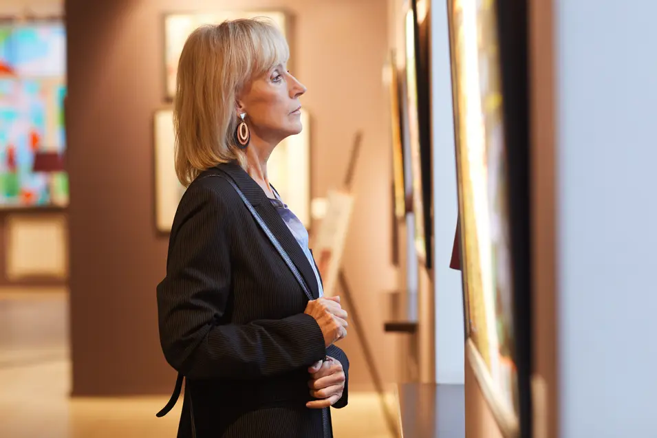 woman looking at a painting