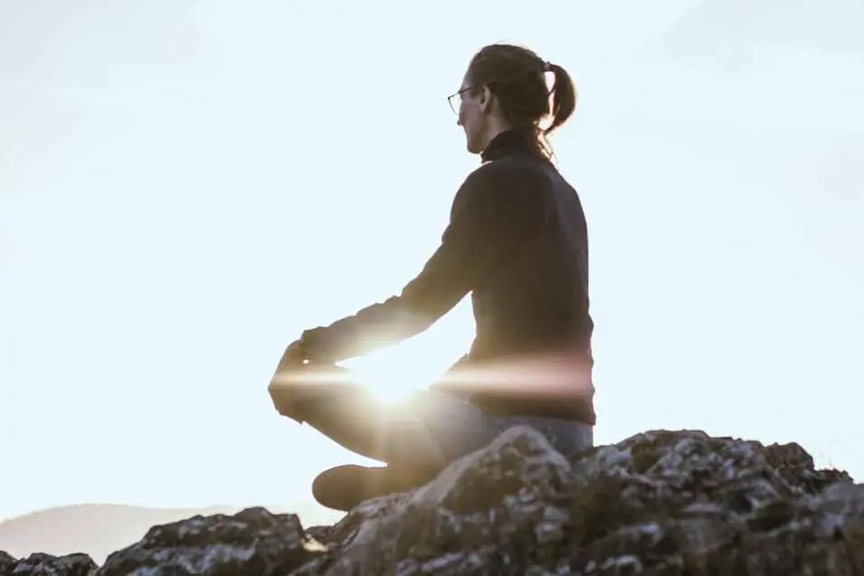 woman sitting on rocks
