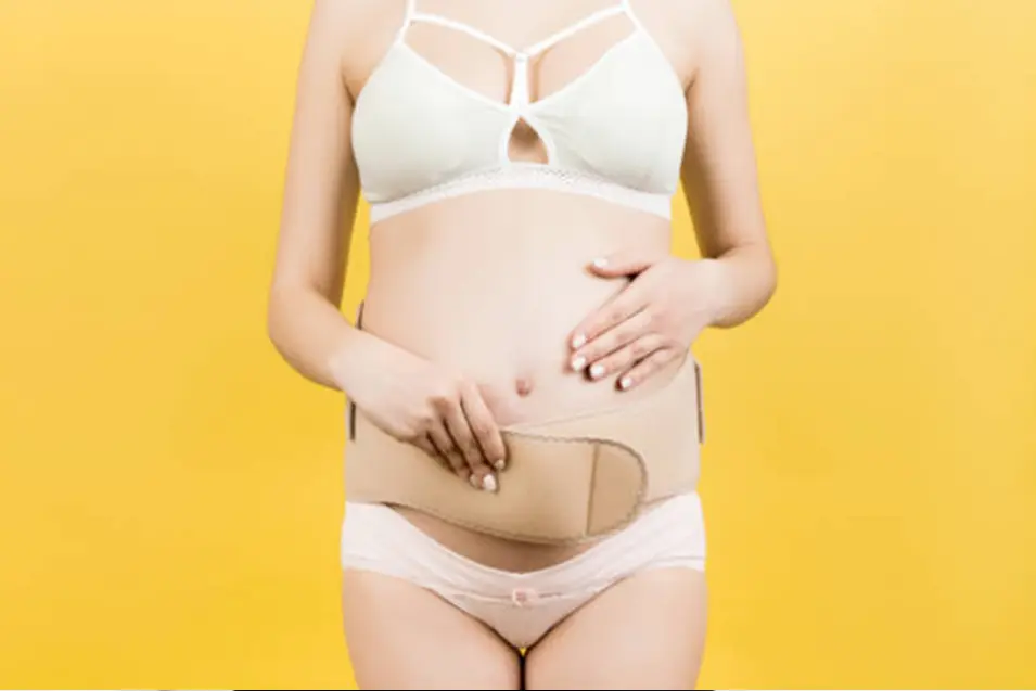 Pregnant woman on yellow background